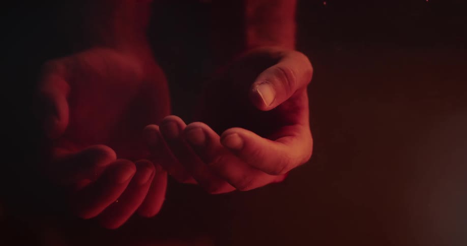 Hand float unmoving in red tinted water
