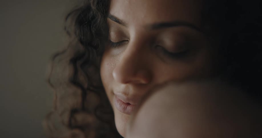 A mother holding her young infant son