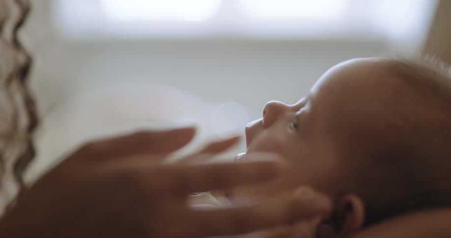 A mother is holding her baby