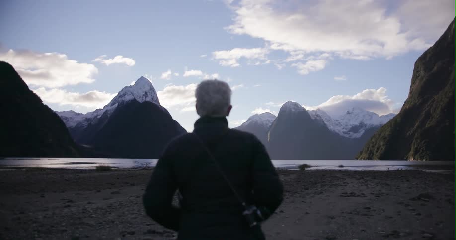 Woman walks towards a lake