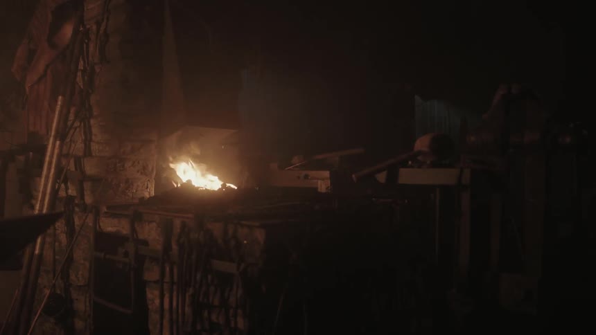 A fire burns in this blacksmith shop