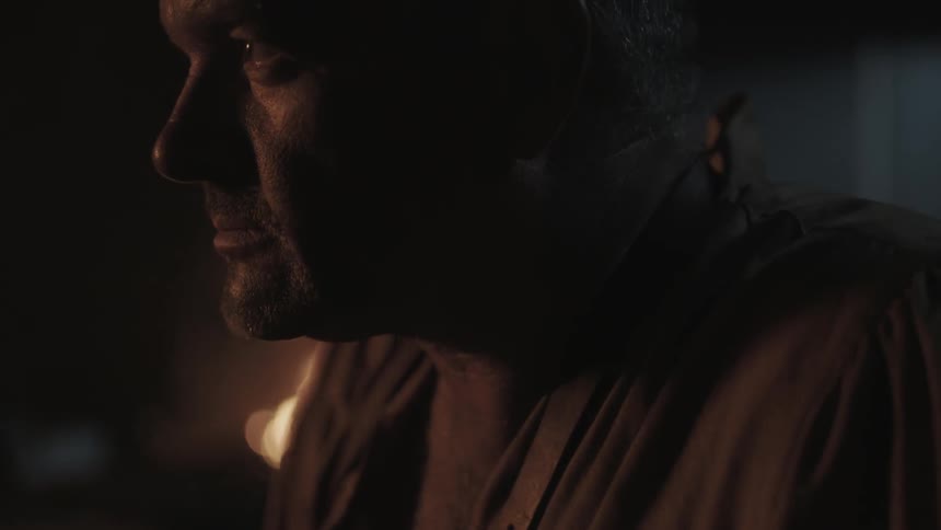 A man slowly opens his eyes and looks up