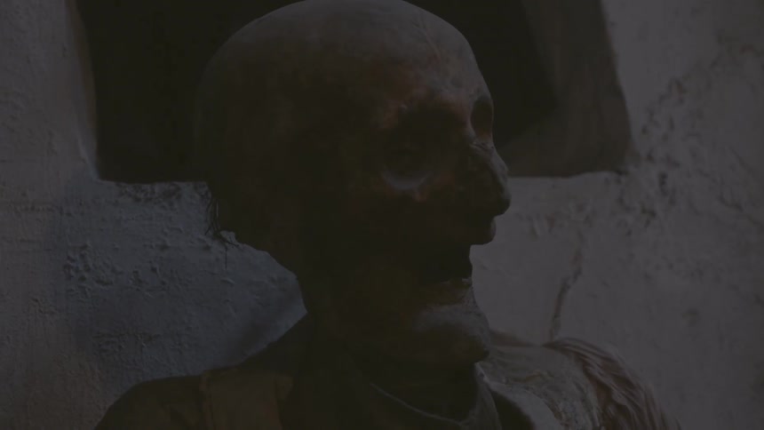 A mummified corpse sits in a crypt