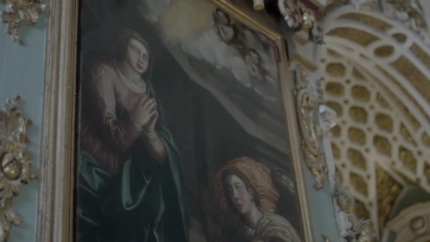A painting hanging on an ornately decorated wall
