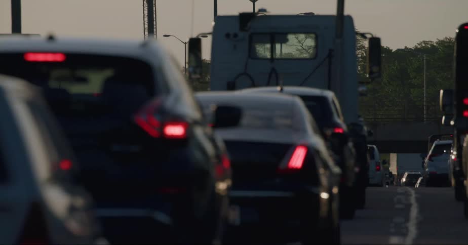 Cars and trucks in lanes of backed up traffic