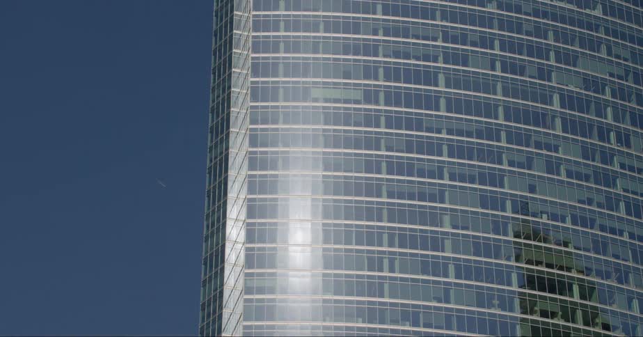 The sun reflects off the building
