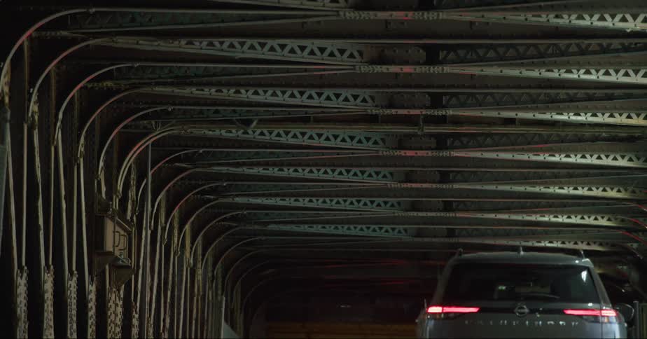 Traffic on a road turns and moves through a tunnel
