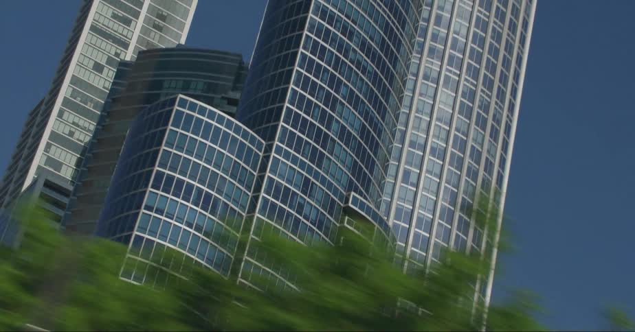 Windows on towers and skyscrapers reflect the sunlight as they stand tall over the city