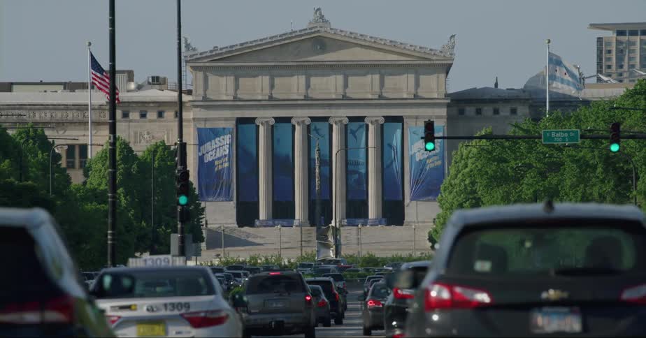 Cars traveling on a busy chicago street toward the field museum
