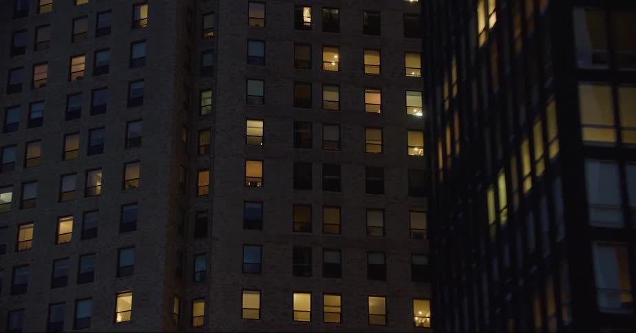 Aerial view of illuminated tall apartment buildings in the city