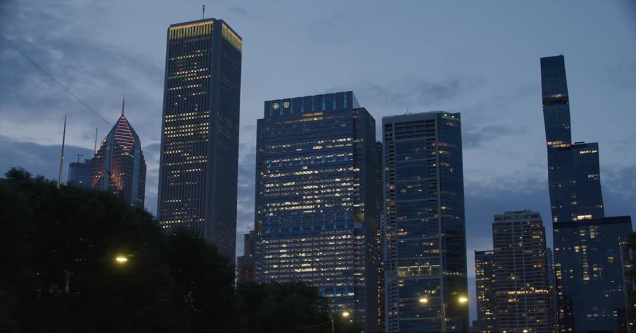 Exterior view of illuminated tall skyscrapers at dusk in the city