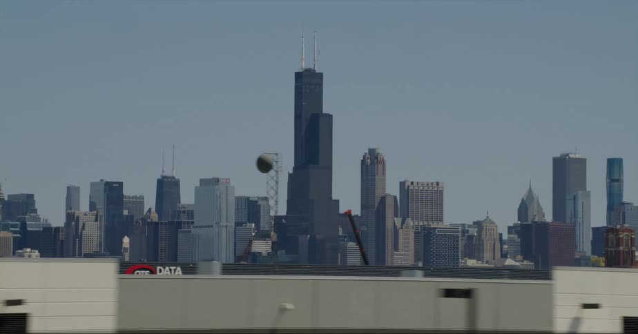 A city skyline is visible in the distance from a highway