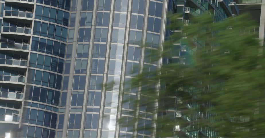The sun reflects off the large buildings