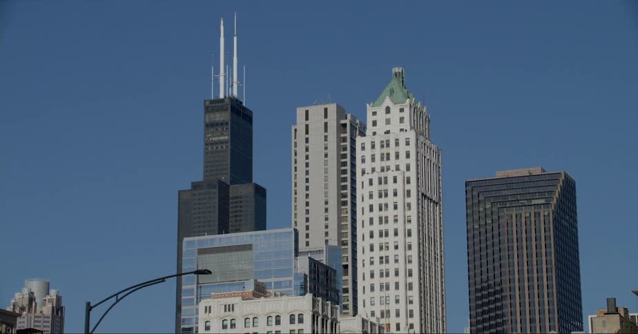 Skyscrapers and and high rise buildings seen from vehicle driving on highway in the city