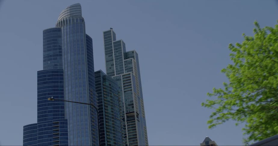 Exterior view of high rise buildings and office buildings against blue sky in the city
