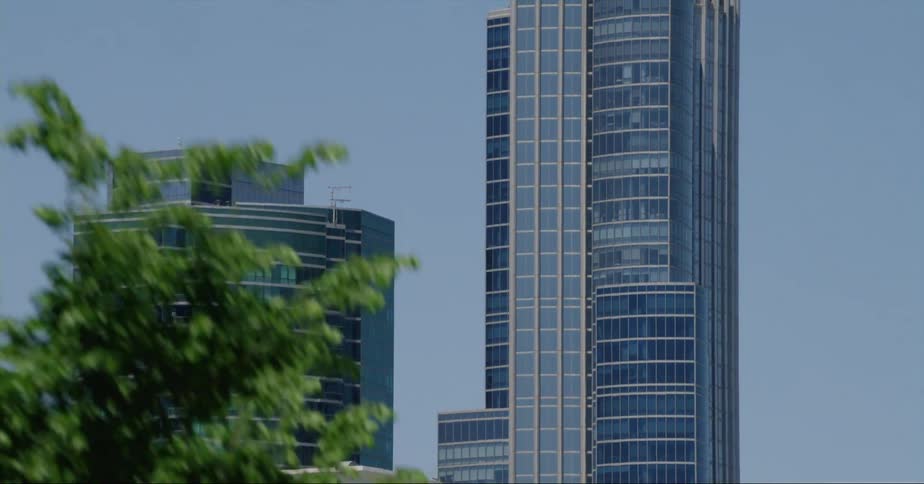 Skyscrapers under a deep blue sky on the skyline of chicago seen from a moving vehicle