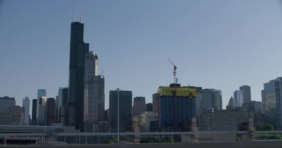 Towers and skyscrapers stand tall among buildings on the city skyline as a new building is being constructed
