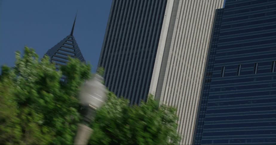 Chicago skyscrapers against a bright blue sky from street level