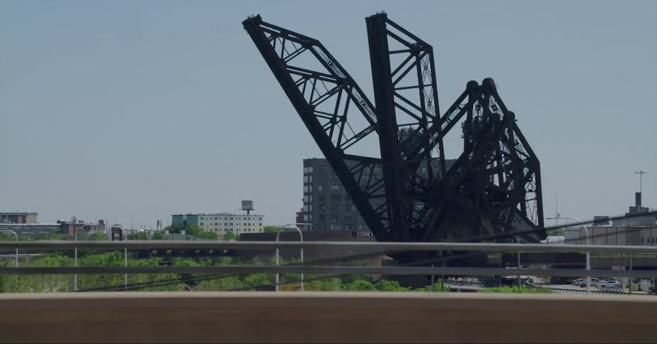 Cars driving past a large structure in a city