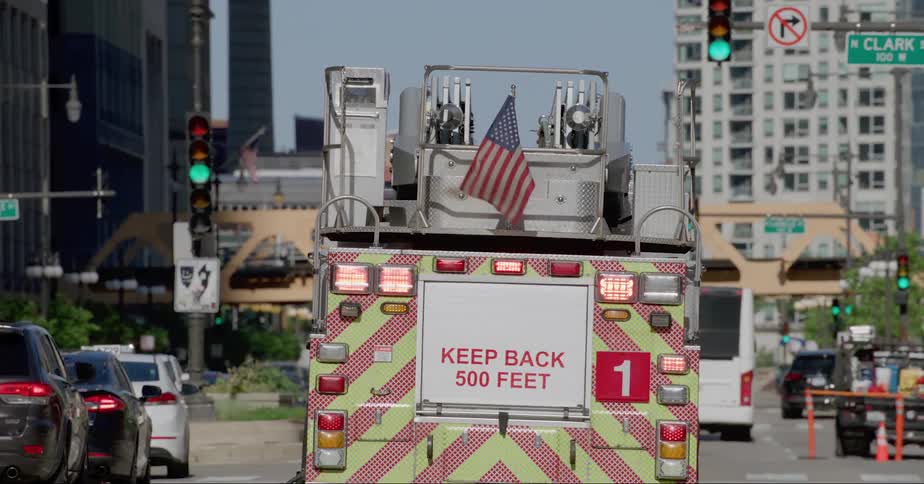 Fire truck drives on the streets of chicago at daytime