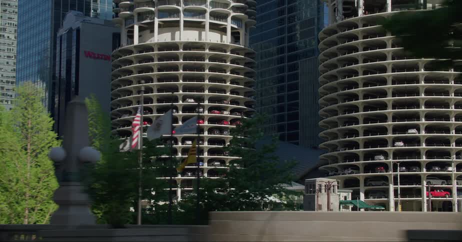 Cars traveling on an urban road with skyscrapers in the distance