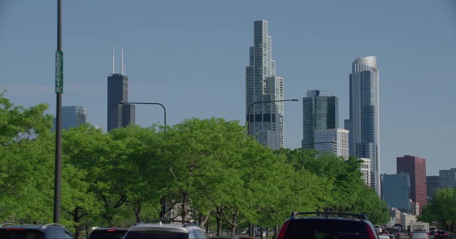 Cars driving towards high rise office buildings in a city