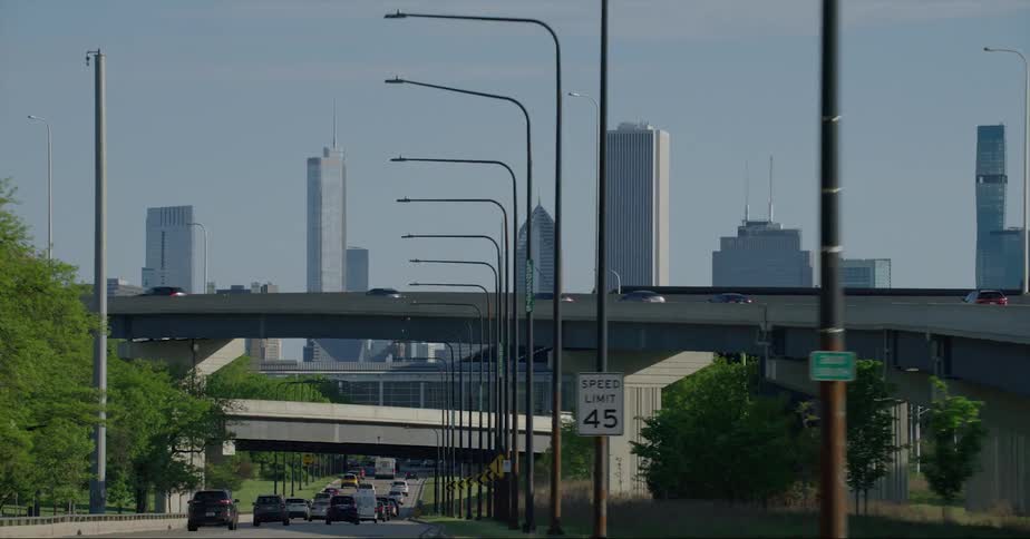 Skyscrapers on the city skyline seen from a vehicle driving on the freeway at daytime