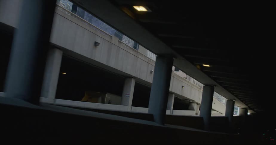 Traveling on a dark tunnel road out of a downtown parking garage