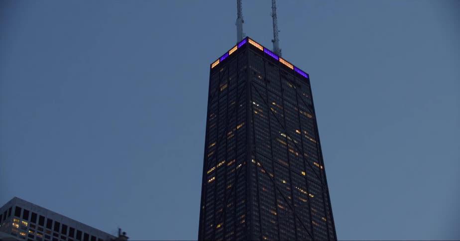 Lights shine from windows of downtown buildings at night