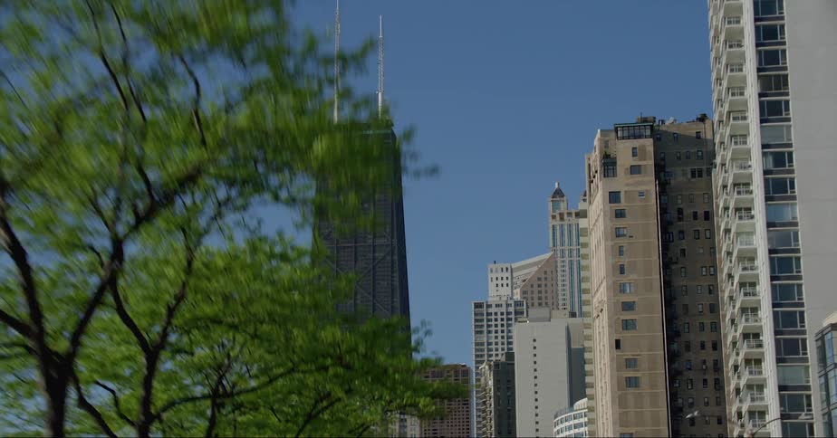 Moving into downtown tall buildings and skyscrapers stand tall overlooking the city