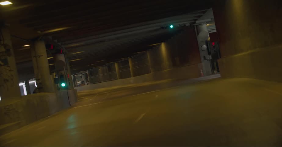 A vehicle drives through an intersection in a downtown tunnel