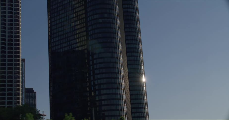 Sunlight reflects off the mirrored windows on a skyscraper
