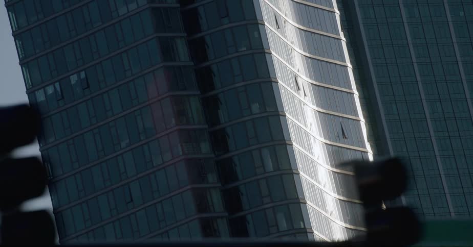 Bright sunlight reflects off tall skyscapers downtown