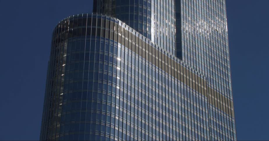Glass facade of the trump tower on the chicago skyline under a deep blue sky