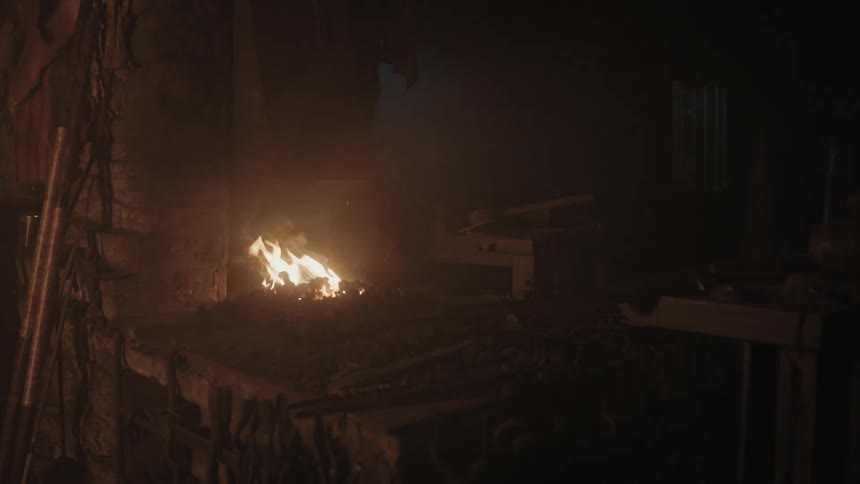 A fire burns in a dark room