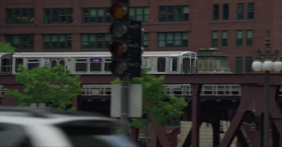 A subway and vehicles driving through a city