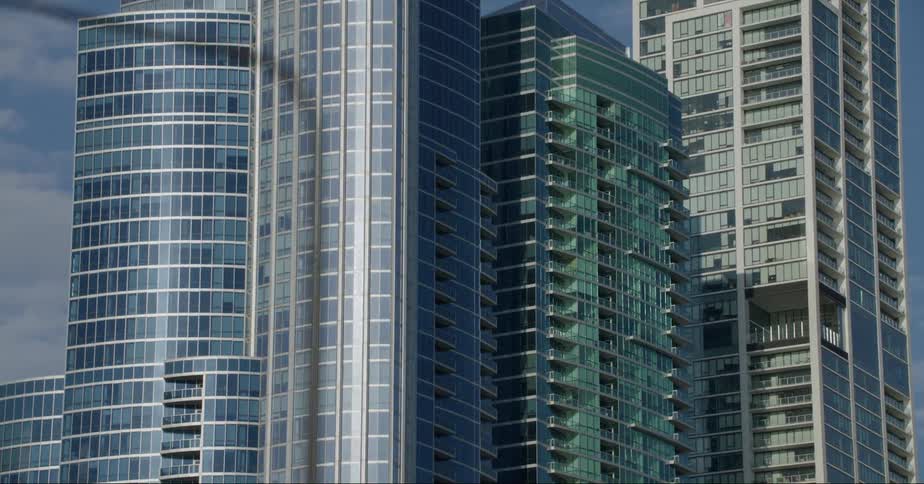 Glass facade of tall skyscrapers on the city skyline at daytime