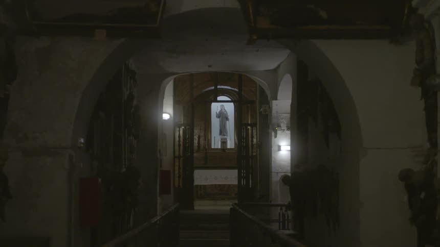 A hall leads to a church ahead