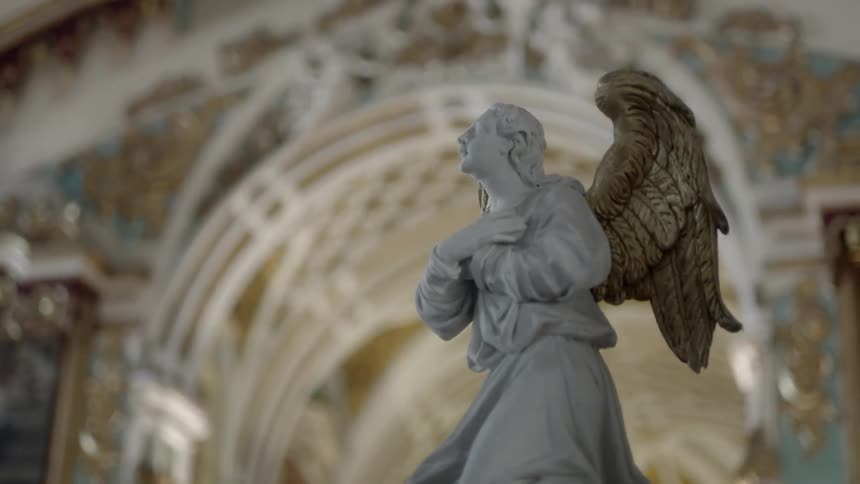 An angel statue is in a church