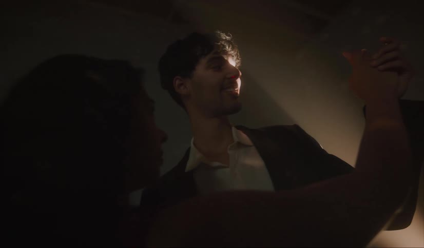 A couple are dancing in the dark