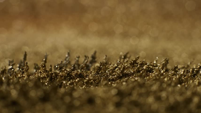 Shiny gold shards rise and grow taller when they stretch upward and then bend back down