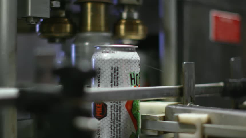 Cans moving on a conveyor belt in a factory