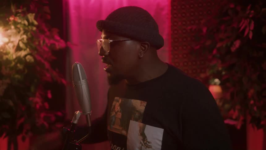 A man sings in to a microphone