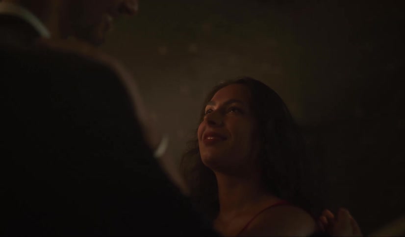 Young happy couple dancing slowly on a dimly lit party