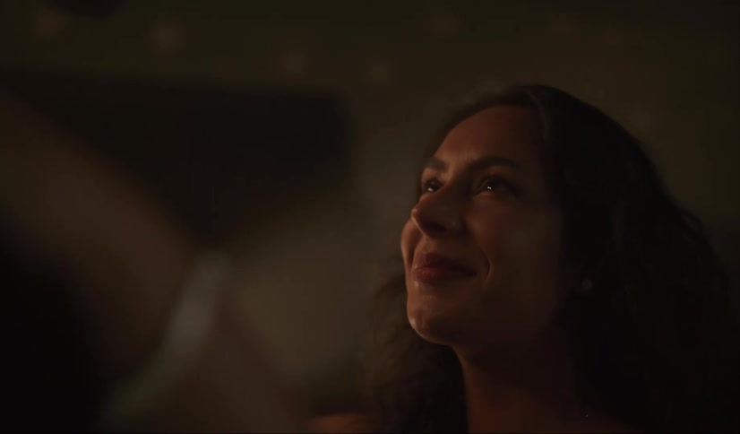 A woman is looking up and smiling
