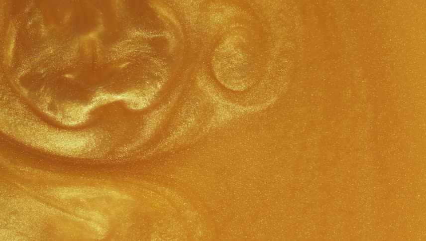 Shimmering golden liquid flowing and swirling