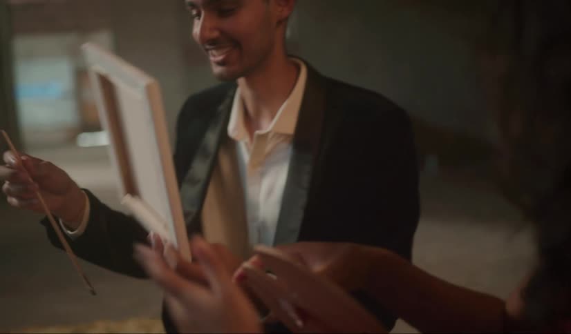 A young man and woman dressed for a date share art painting supplies