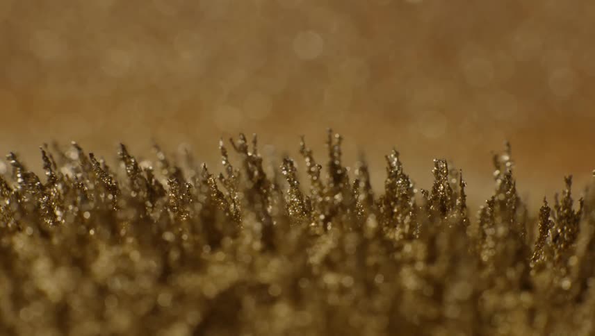 Shiny gold shards move and grow taller when they stretch upward and then bend back down
