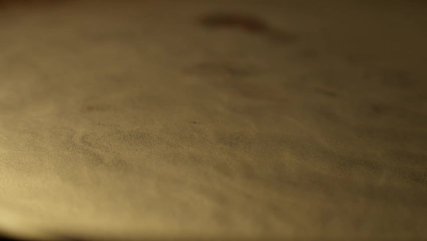 Golden peaks and ridges form on a surface then subside with a wave