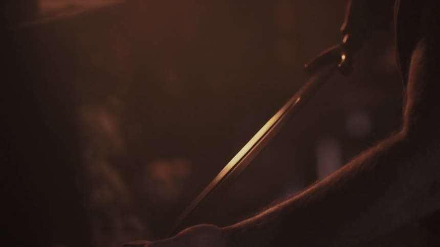 A sword is lifted up and examined